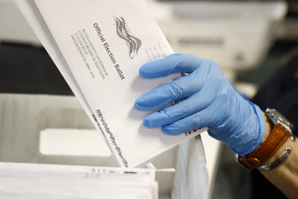 FILE - In this May 27, 2020 file photo, a worker processes mail-in ballots at the Bucks County Board of Elections office prior to the primary election in Doylestown, Pa. A statewide court on Friday, Jan. 28, 2022 declared that Pennsylvania’s expansive two-year-old mail-in voting law is unconstitutional, agreeing with challenges by Republicans who soured on mail-in voting after then-President Donald Trump began baselessly attacking it as rife with fraud in 2020′s campaign. (AP Photo/Matt Slocum, File)