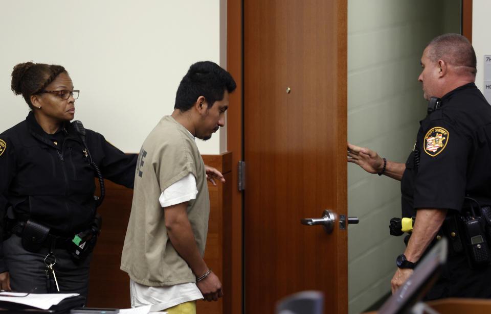 Franklin County Sherriff's deputies escort Gerson Fuentes, center, the man accused of raping a 10-year-old girl who then traveled to Indiana to have an abortion, out of Franklin County common pleas court following his bond hearing in Columbus, Ohio, Thursday, July 28, 2022. Judge Julie Lynch denied bond. (AP Photo/Paul Vernon)