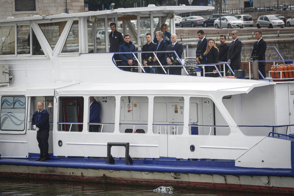 A wreath is lowered in the Danube during a memorial ceremony for the victims, one year after the Mermaid boat accident, in Budapest, Hungary, Friday, May 29, 2020. Commemorations are taking place on the one year anniversary of the Danube River tragedy in which a sightseeing boat carrying mostly tourists from South Korea sank after a collision with a river cruise ship that killed at least 27 people. (AP Photo/Laszlo Balogh)