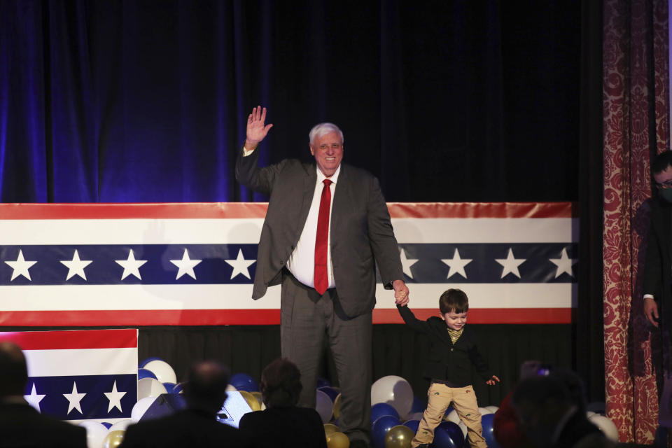 West Virginia Gov. Jim Justice celebrates his reelection with his grandson, J.C. Justice, at The Greenbrier Resort, Tuesday, Nov. 3, 2020, in White Sulphur Springs, W.Va. (AP Photo/Chris Jackson)