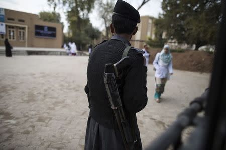 A policeman stands guard at the Competence and Trauma Centre for Journalists inside a university's psychology department in Peshawar November 24, 2014. REUTERS/Zohra Bensemra