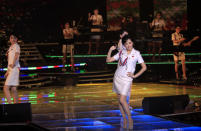 In this Friday, March 28, 2014 photo, singers of the Moranbong Band, Jong Su Hyang, foreground, and Pak Mi Kyong, left perform on their stage in Pyongyang, North Korea. Step aside, Sea of Blood Opera. North Korean leader Kim Jong Un’s favorite guitar-slinging, miniskirt-sporting girl group, the Moranbong Band, is back. And these ladies know how to shimmy. (AP Photo/Jon Chol Jin)