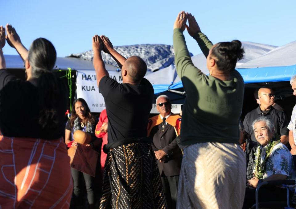 Hawaii’s governor, David Ige, right, watches a performance during a visit to the ninth day of protests against the Thirty Meter Telescope, on 23 July.