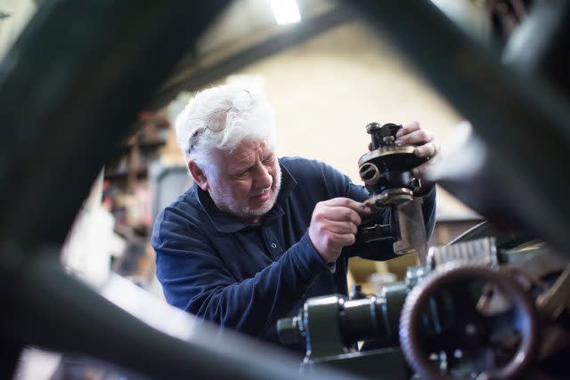 Derek Jenkins, a gunsmith for John Slough, works on a field gun