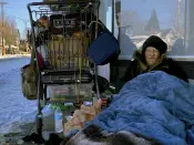 Tim Varner, 57, uses blankets to stay warm in the snow as he huddles with his belongings in a storefront in Portland, Ore. on Friday, Feb. 24, 2023. The thousands of people living on Portland's streets have struggled to stay warm after a storm on Wednesday dumped nearly a foot of snow, resulting in the city's second snowiest day on record. (AP Photo/Claire Rush)