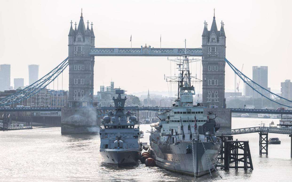 Germany's Braunschweig F260 warship (left) moored alongside HMS Belfast at London Bridge