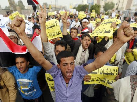 Anti-Houthi protesters shout slogans as they demonstrate in support of Yemen's president Abd-Rabbu Mansour Hadi in Sanaa February 23, 2015. The signs read: "No to the militia. Yes to the civil state" and "No to the Houthi coup." REUTERS/Khaled Abdullah