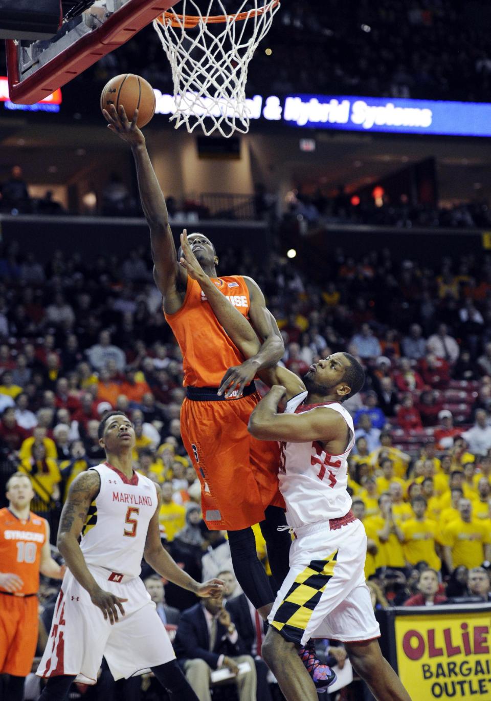 Syracuse forward Jerami Grant, center, goes to the basket against Maryland forward Damonte Dodd, right, and Nick Faust (5) during the first half of an NCAA college basketball game, Monday, Feb. 24, 2014, in College Park, Md. (AP Photo/Nick Wass)