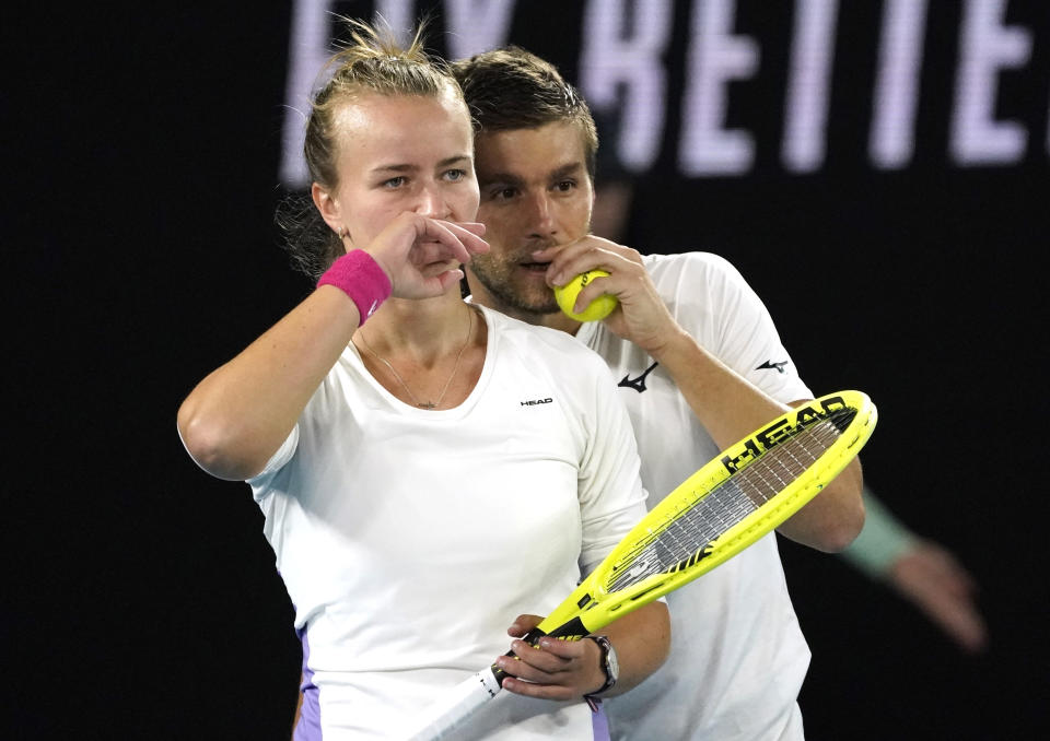 Barbora Krejcikova, left, of the Czech Republic and Croatia's Nikola Mektic talk during their match against Bethanie Mattek-Sands of the U.S. and partner Britain's Jamie Murray in the mixed doubles final at the Australian Open tennis championship in Melbourne, Australia, Saturday, Feb. 1, 2020. (AP Photo/Lee Jin-man)