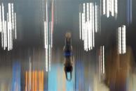 A competitor dives during a practice session at the Aquatics Centre in the Olympic Park ahead of the 2012 Summer Olympics in London, Friday, July 27, 2012. (AP Photo/Mark J. Terrill)