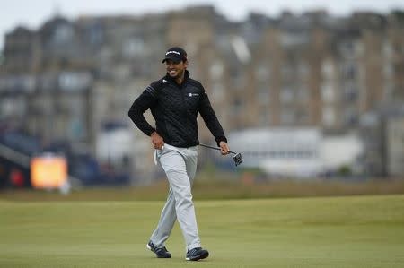 Jason Day of Australia smiles as he walks across the 16th green during the third round of the British Open golf championship on the Old Course in St. Andrews, Scotland, July 19, 2015. REUTERS/Lee Smith