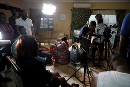 Crew members film a scene on the set of a ROK's film in Lagos