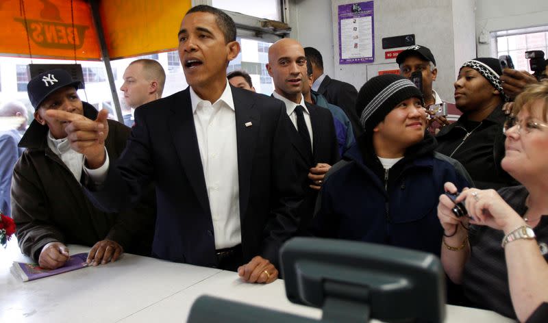 FILE PHOTO: U.S. President-elect Barack Obama places an order for lunch with Washington Mayor Adrian Fenty at Ben's Chili Bowl Restaurant in Washington