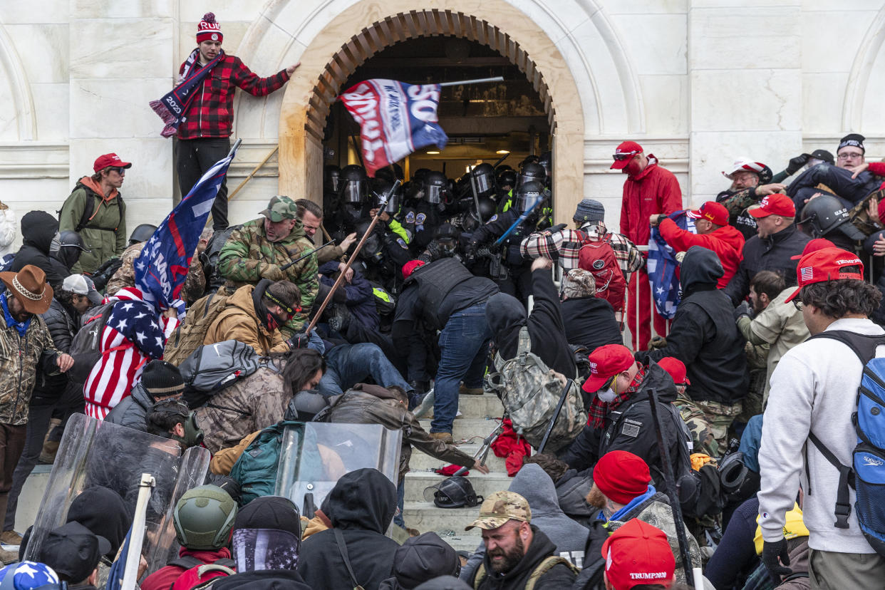 Pro-Trump rioters clash with police outside an entrance to the Capitol on Jan. 6, 2021.