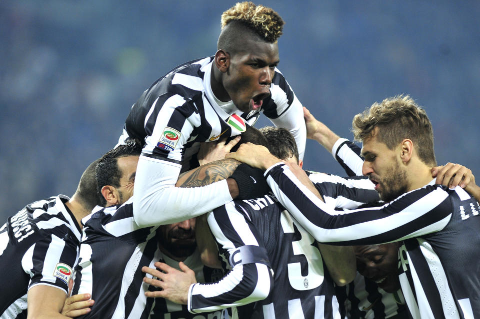 Juventus defender Giorgio Chiellini, back to camera, celebrates with teammates after scoring during a Serie A soccer match between Juventus and Inter Milan at the Juventus stadium, in Turin, Italy, Sunday, Feb. 2, 2014. (AP Photo/Massimo Pinca)