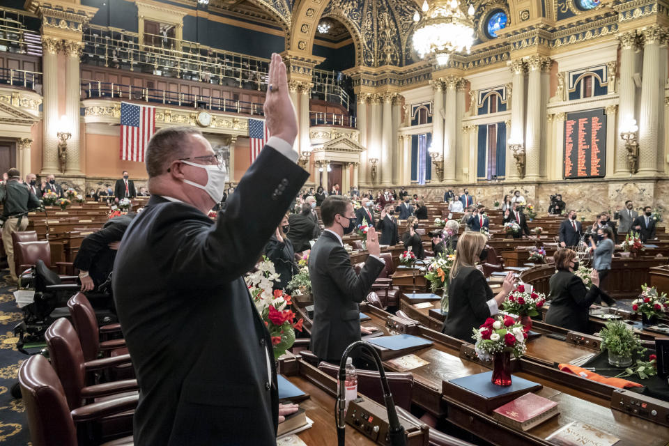 First term legislators of the Pennsylvania House of Representatives are sworn-in, Tuesday, Jan. 5, 2021, at the state Capitol in Harrisburg, Pa. The ceremony marks the convening of the 2021-2022 legislative session of the General Assembly of Pennsylvania. (AP Photo/Laurence Kesterson)