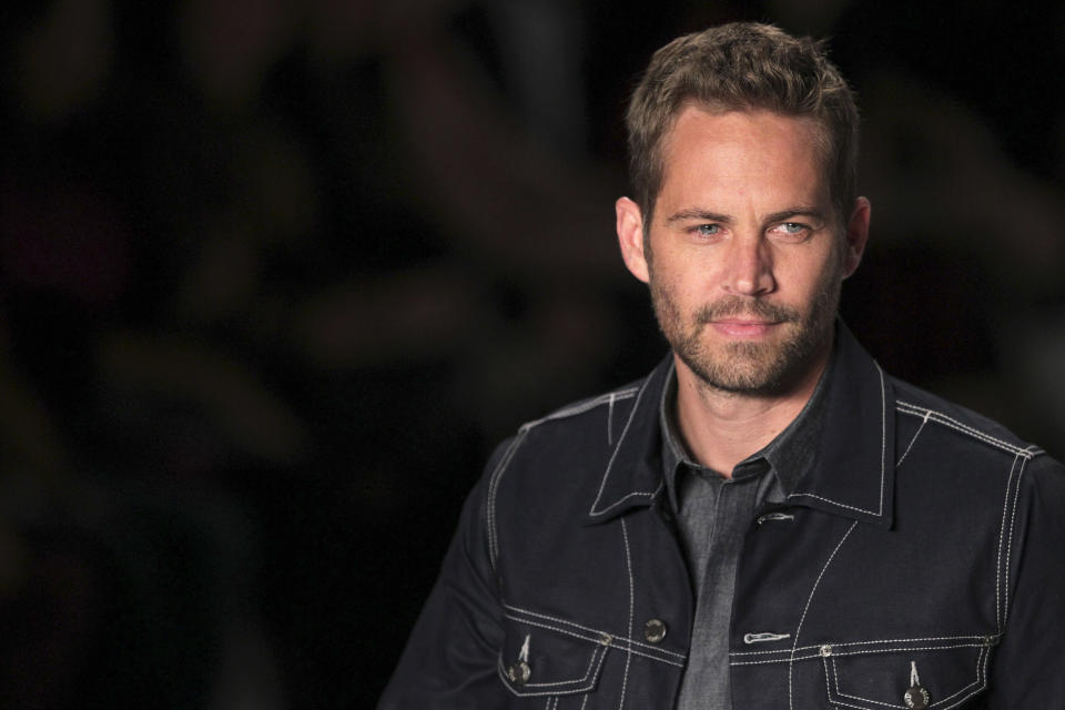 U.S. actor Paul Walker presents a creation from Colcci's 2013/2014 summer collection during Sao Paulo Fashion Week March 21,
2013. REUTERS/Filipe Carvalho (BRAZIL - Tags: FASHION ENTERTAINMENT)