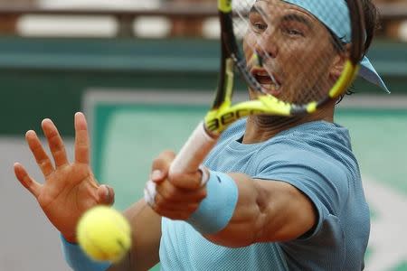 Nadal returns the ball. REUTERS/Pascal Rossignol