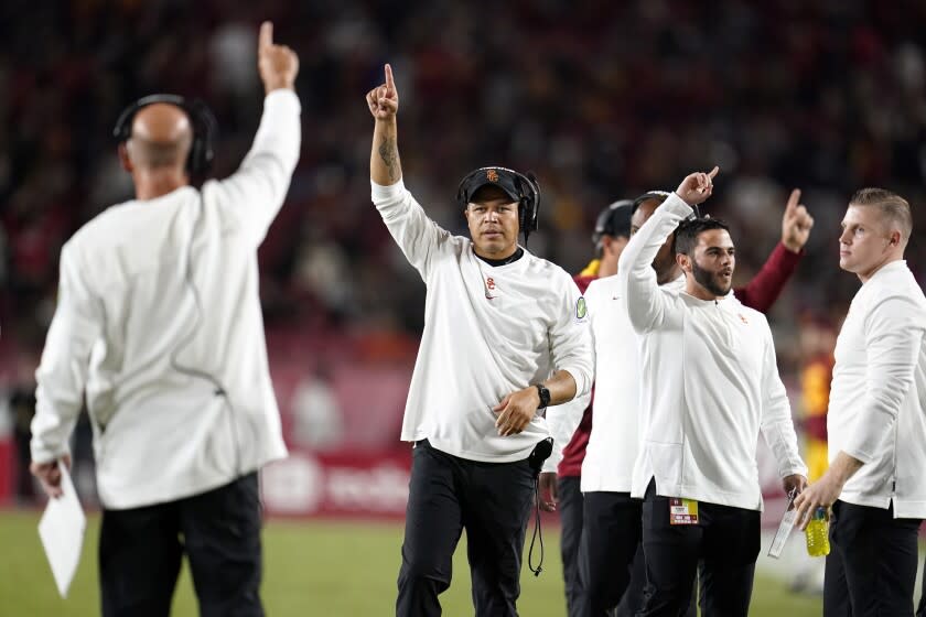 Southern California head coach Donte Williams, center, celebrates with fellow coaches after a touchdown by running back Keaontay Ingram during the first half of an NCAA college football game against Oregon State Saturday, Sept. 25, 2021, in Los Angeles. (AP Photo/Marcio Jose Sanchez)