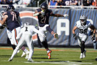 Chicago Bears running back D'Onta Foreman (21) tries to get past Las Vegas Raiders safety Marcus Epps (1) in the second half of an NFL football game Sunday, Oct. 22, 2023, in Chicago. (AP Photo/Charles Rex Arbogast)
