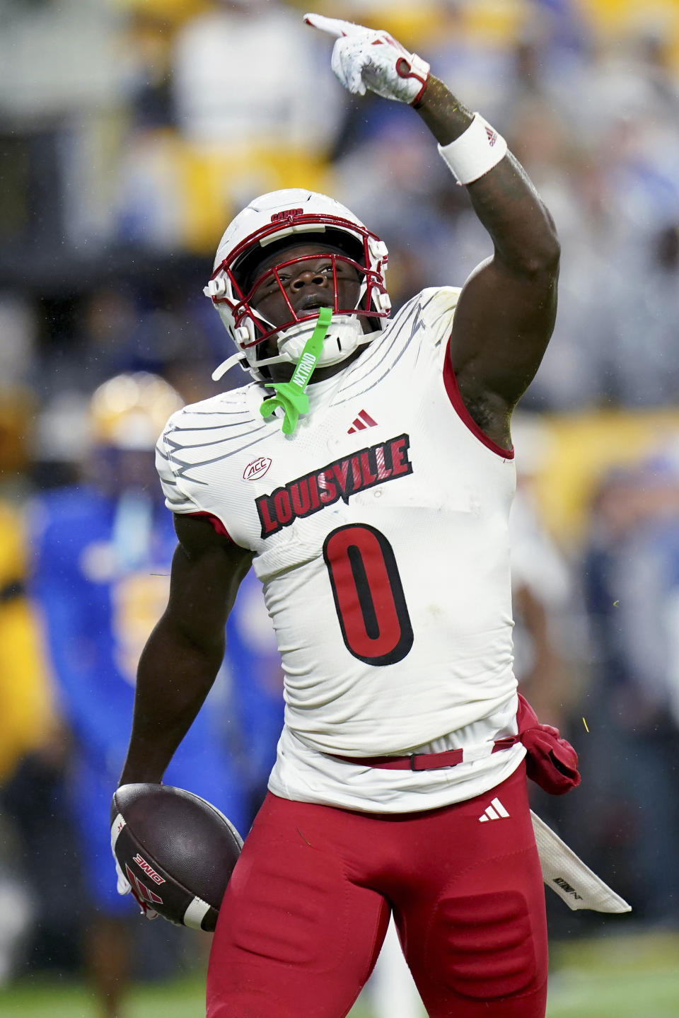 Louisville wide receiver Chris Bell celebrates after scoring a touchdown against Pittsburgh during the first half of an NCAA college football game in Pittsburgh, Saturday, Oct. 14, 2023. (AP Photo/Matt Freed)