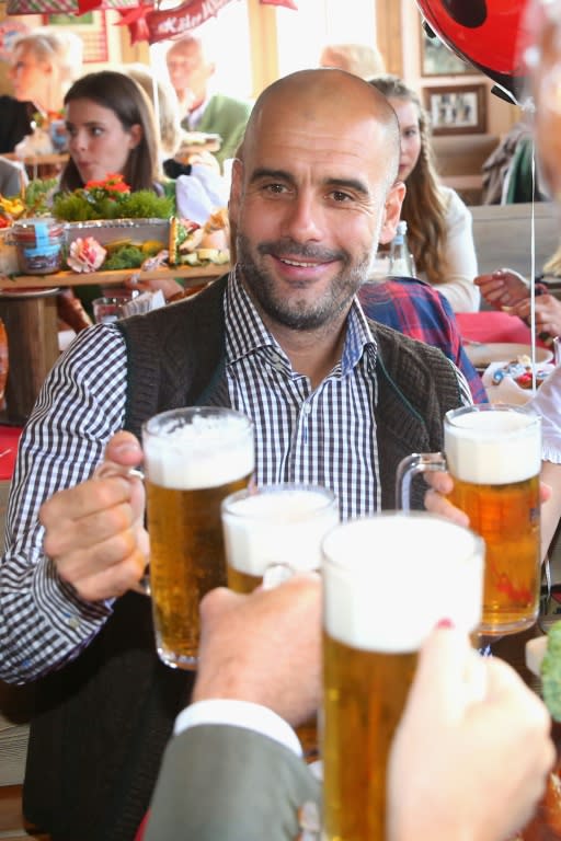 Bayern Munich's head coach Pep Guardiola takes a break from football during the team's annual visit to the Oktoberfest beer festival, in Munich, on September 30, 2015