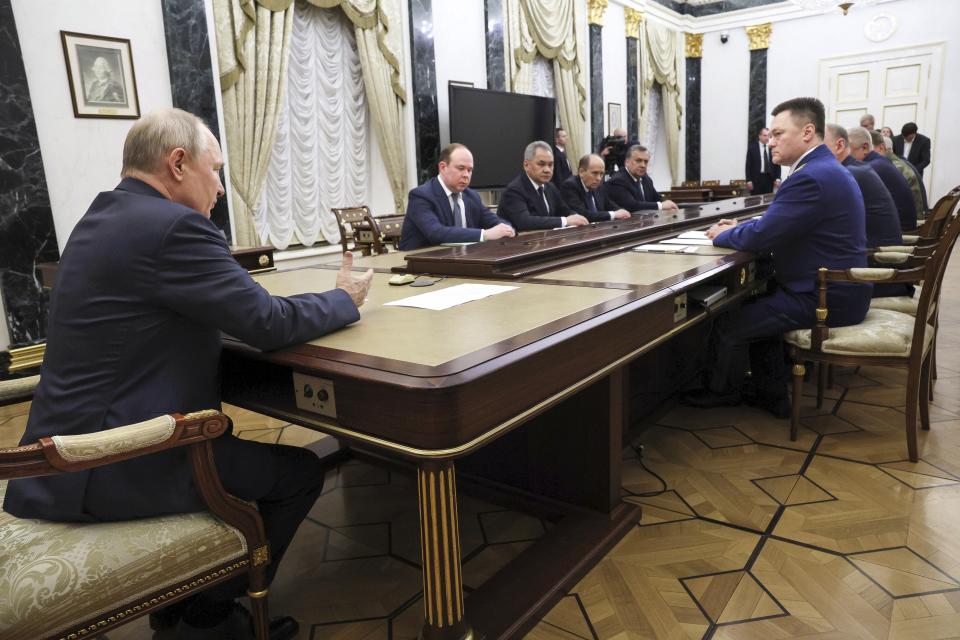 FILE - Russian President Vladimir Putin, back to the camera, chairs a Security Council meeting in Moscow, Russia, Monday, June 26, 2023. After Prigozhin announced his intentions June 23 to act against Russia's defense minister, the FSB issued a statement urging Wagner fighters not to follow the rogue commander and for the troops "to detain him." (Gavriil Grigorov, Sputnik, Kremlin Pool Photo via AP, File)