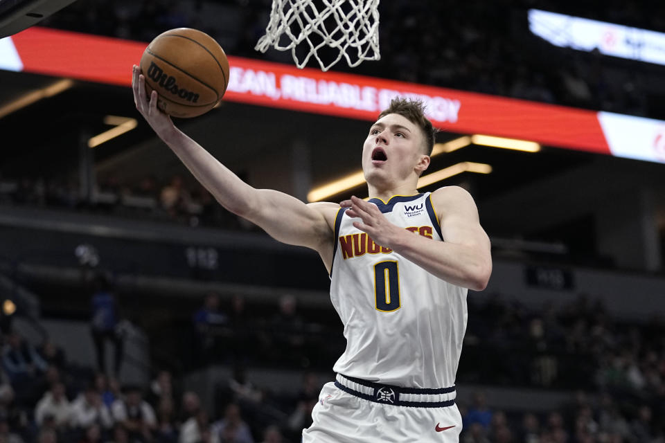 Denver Nuggets guard Christian Braun (0) goes up for a shot during the second half of an NBA basketball game against the Minnesota Timberwolves, Sunday, Feb. 5, 2023, in Minneapolis. (AP Photo/Abbie Parr)