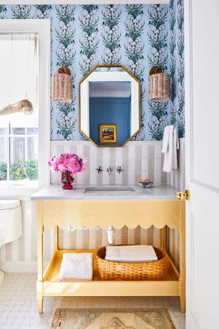 PHOTOGRAPHY BY LAUREY W. GLENN; STYLING BY KENDRA SURFACE An Oomph vanity in a bright custom yellow adds personality to the downstairs guest bath.