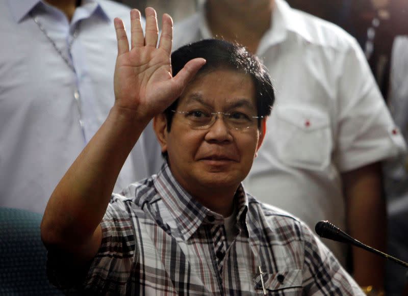 FILE PHOTO: Senator Panfilo Lacson waves to reporters before the start of a news conference at the Senate headquarters in Pasay city, Metro Manila