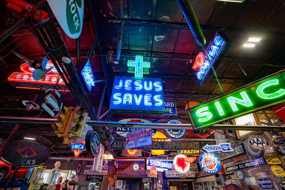 Signs fill the walls and ceiling of Rob Wolfe's warehouse in Davenport, Wednesday, Dec. 13, 2023.