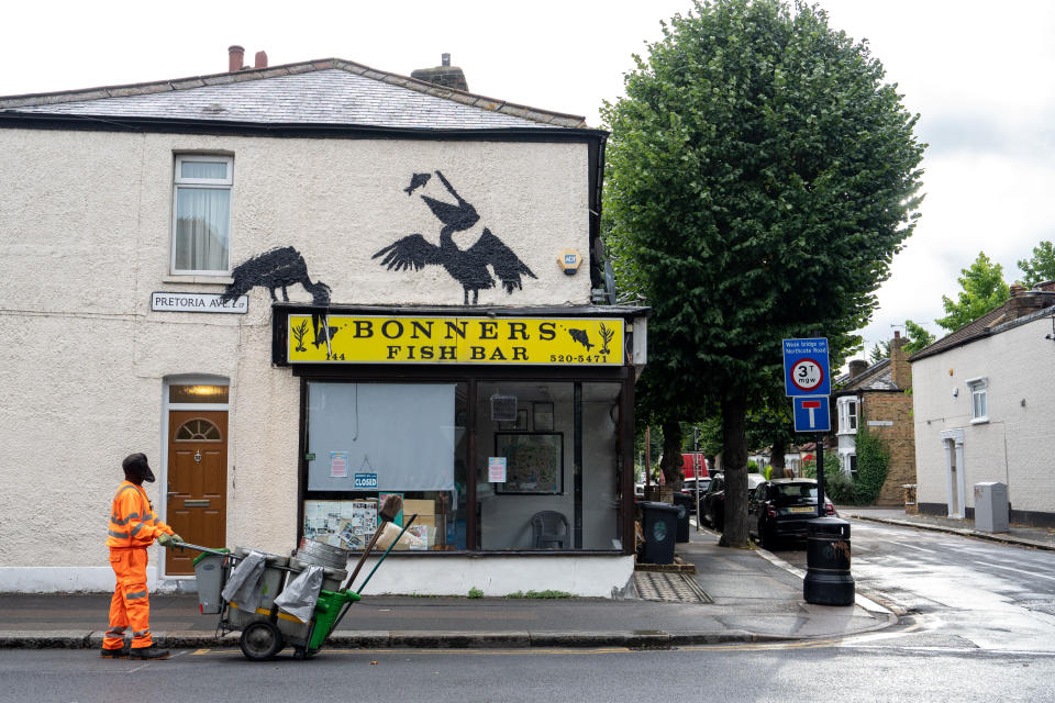 New artwork by Banksy showing pelicans eating fish appears on the side of Bonners Fish Bar in Walthamstow. (PA)