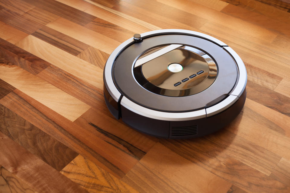 Robotic vacuum cleaner on a hardwood floor.