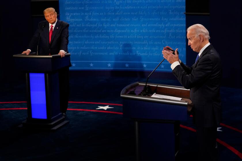 Debate stage with Donald Trump on the left and Joe Biden on the right, each behind a podium