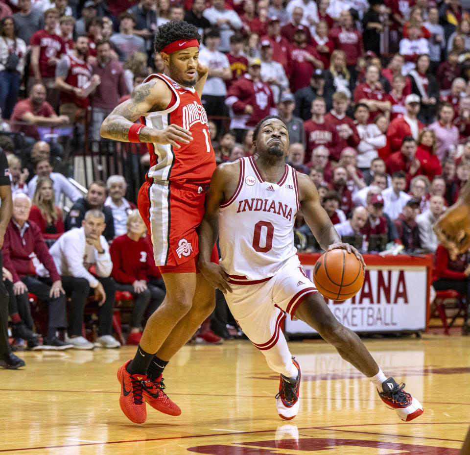 Indiana guard Xavier Johnson (0) brushes past Ohio State guard Roddy Gayle Jr. during the second half of an NCAA college basketball game Saturday, Jan. 6, 2024, in Bloomington, Ind. (AP Photo/Doug McSchooler)