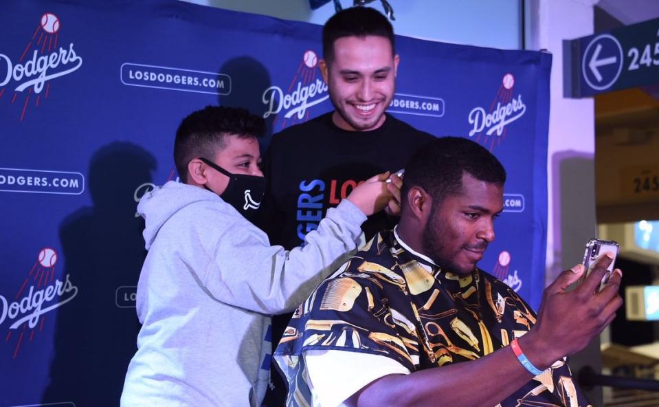 Yasiel Puig gets a haircut from a kid battling cancer during Puig’s Pizza and Shave Party. (Twitter/@Dodgers)