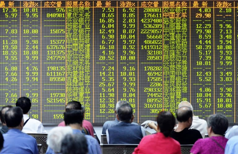 Investors sit in front of a screen showing market movements in a stock firm in Hangzhou, eastern China's Zhejiang province on July 8, 2015