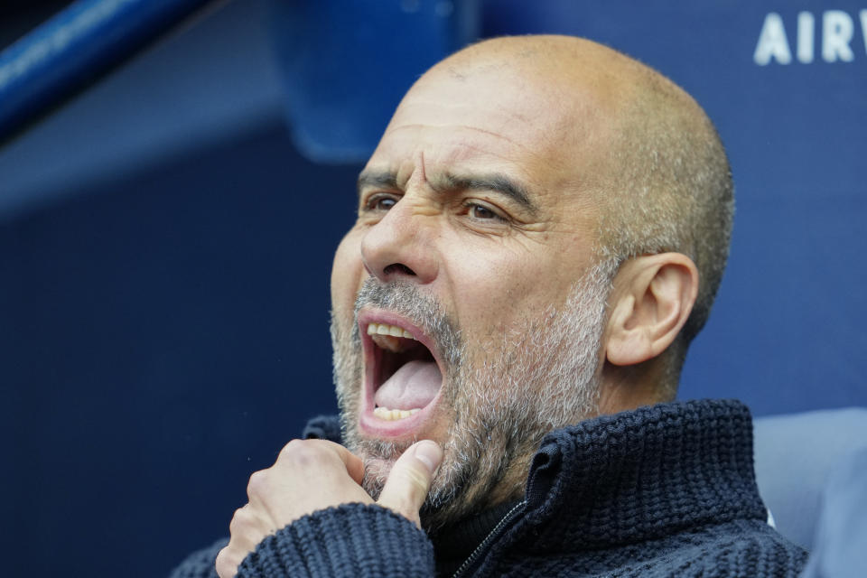 Manchester City's head coach Pep Guardiola sits on the bench prior to the English Premier League soccer match between Manchester City and Liverpool at Etihad stadium in Manchester, England, Saturday, April 1, 2023. (AP Photo/Jon Super)