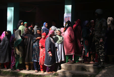 Women wait in a queue to cast their votes outside a polling station in Kund, in south Kashmir's Kulgam district April 29, 2019. REUTERS/Danish Ismail