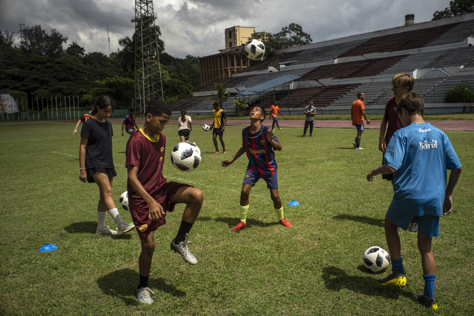 Youths train at the Pedro Marrero stadium in Havana, Cuba, Wednesday, Sept. 14, 2022. Soccer coaches across Cuba are training dozens of players as part of a new program to elevate the sport's profile and status in a country that last qualified for the FIFA World Cup in 1938. (AP Photo/Ramon Espinosa)