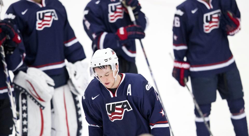 USA's Matt Grzelcyk looks down after his team lost the World Junior Hockey Championships quarter final between USA and Russia in Malmo, Sweden on Thursday, Jan. 2, 2014. (AP Photo / TT News Agency / Andreas Hillergren) ** SWEDEN OUT **