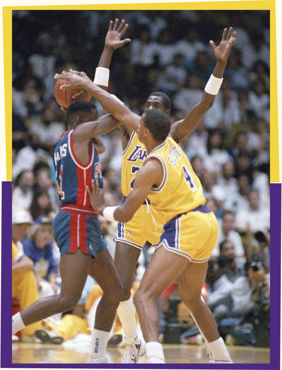 A photo of three basketball players, one with the ball in his hands and two opponents guarding him