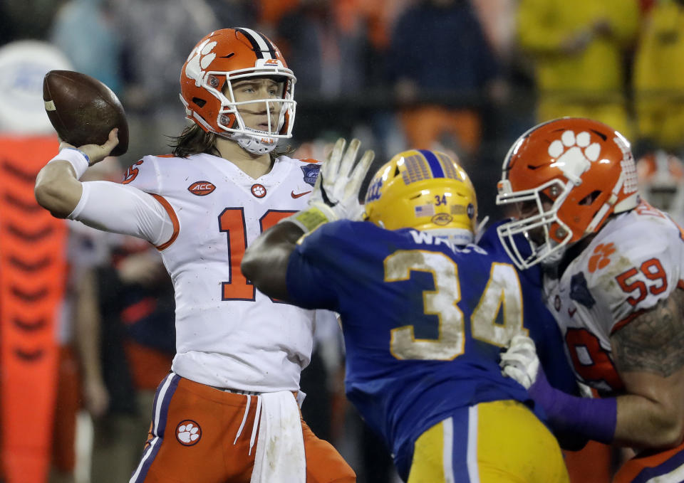 Clemson's Trevor Lawrence (16) looks to pass under pressure from Pittsburgh's Amir Watts (34) in the first half of the Atlantic Coast Conference championship NCAA college football game in Charlotte, N.C., Saturday, Dec. 1, 2018. (AP Photo/Chuck Burton)