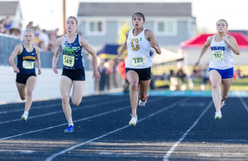 Capital’s Christine Huckins, second from right, swept the 100 and 200 at the 5A District Three meet last week at Middleton High.