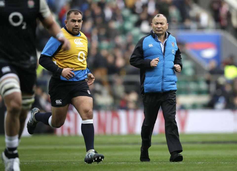 FILE - In this Saturday, March 9, 2019, file photo, England head coach Eddie Jones, right, watches his players warm up ahead of their Six Nations rugby union international match against Italy at Twickenham stadium in London. England has had wild fortunes this Rugby World Cup cycle under Eddie Jones but appears to be running into good form ahead of the tournament in Japan. (AP Photo/Matt Dunham, File)