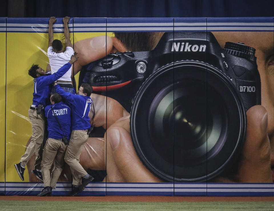 Blue Jays got some comic relief when a fan ran out and slid into 2nd then tried to climb the centre field fence to get away with the Sox leading 13-0 during the game between the Toronto Blue Jays and the Boston Red Sox at The Rogers Centre on April 7, 2013. (Photo by David Cooper/Toronto Star)