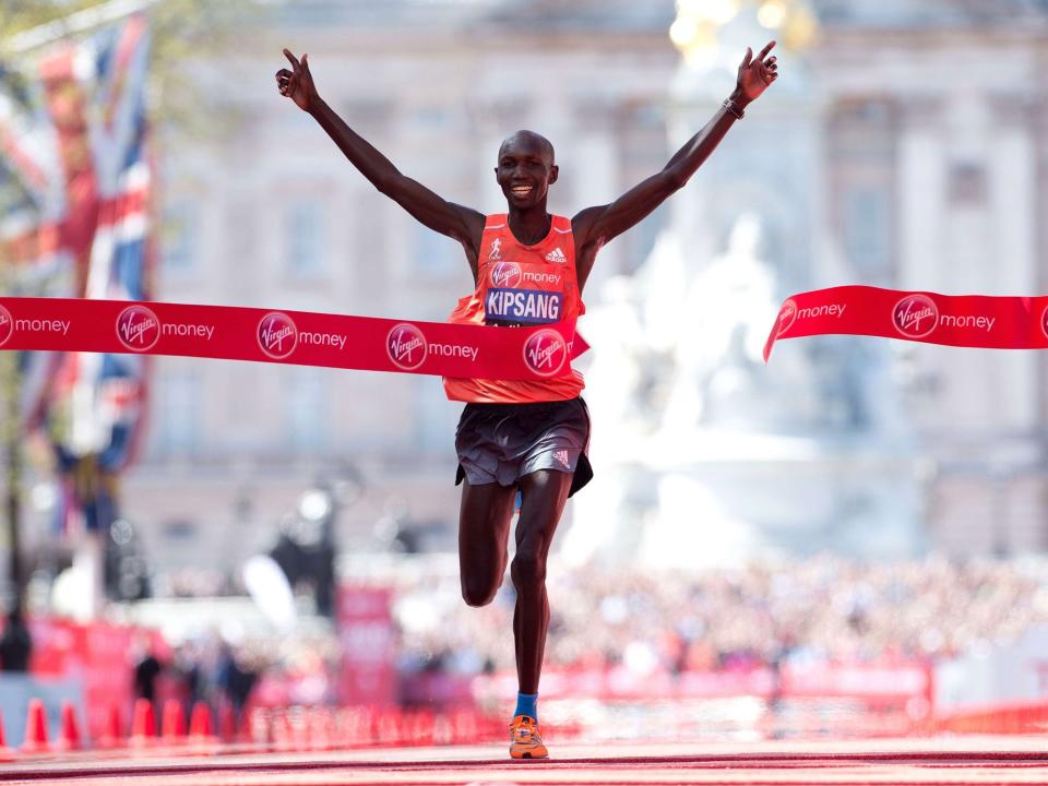 Wilson Kipsang of Kenya crosses the line to win the men's race in the 2014 London Marathon on The Mall in central London