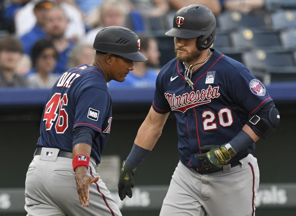 Minnesota Twins' Josh Donaldson (20) is congratulated by third base coach Tony Diaz (46) after hitting a home run against the Kansas City Royals during the first inning of a baseball game Thursday, June 3, 2021, in Kansas City, Mo. (AP Photo/Reed Hoffmann)