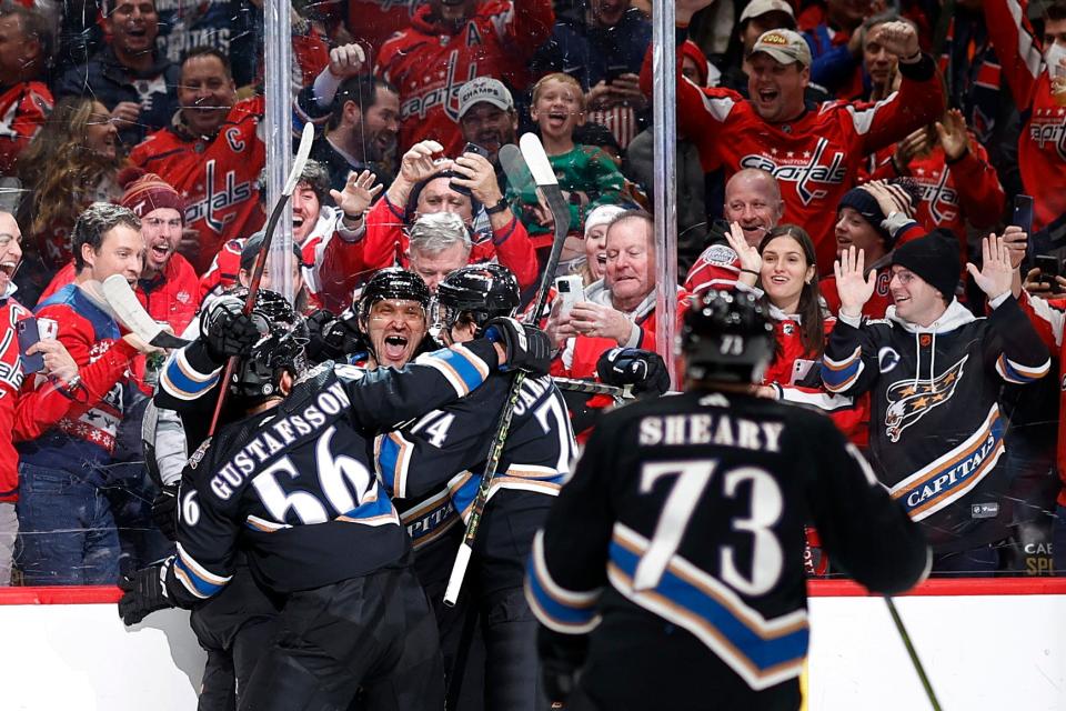 Alex Ovechkin celebrates his 801st goal with his Washington Capitals teammates.