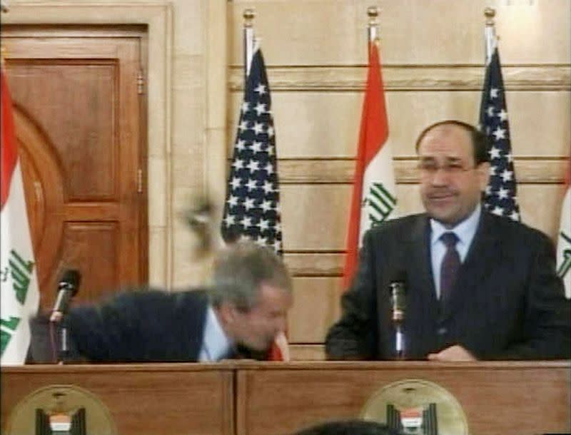 FILE PHOTO: Video frame grab of U.S. President George W. Bush ducking from a shoe during a news conference in Baghdad